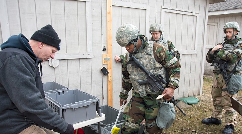 Dennis Meyers, 788th Civil Engineering Squadron Emergency Management Center, left, trains Airmen on chemical decontamination techniques during an exercise on Wright-Patterson Air Force Base, Ohio, Jan. 31, 2018. Personnel operating in a contaminated environment must go through decontamination prior to returning to a “clean” area. (U.S. Air Force photo/R.J. Oriez)