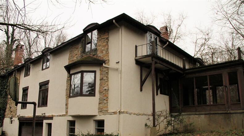 An oversized, 2-car garage is accessible from the rear of the house, and a large workshop has storage and ventilation.