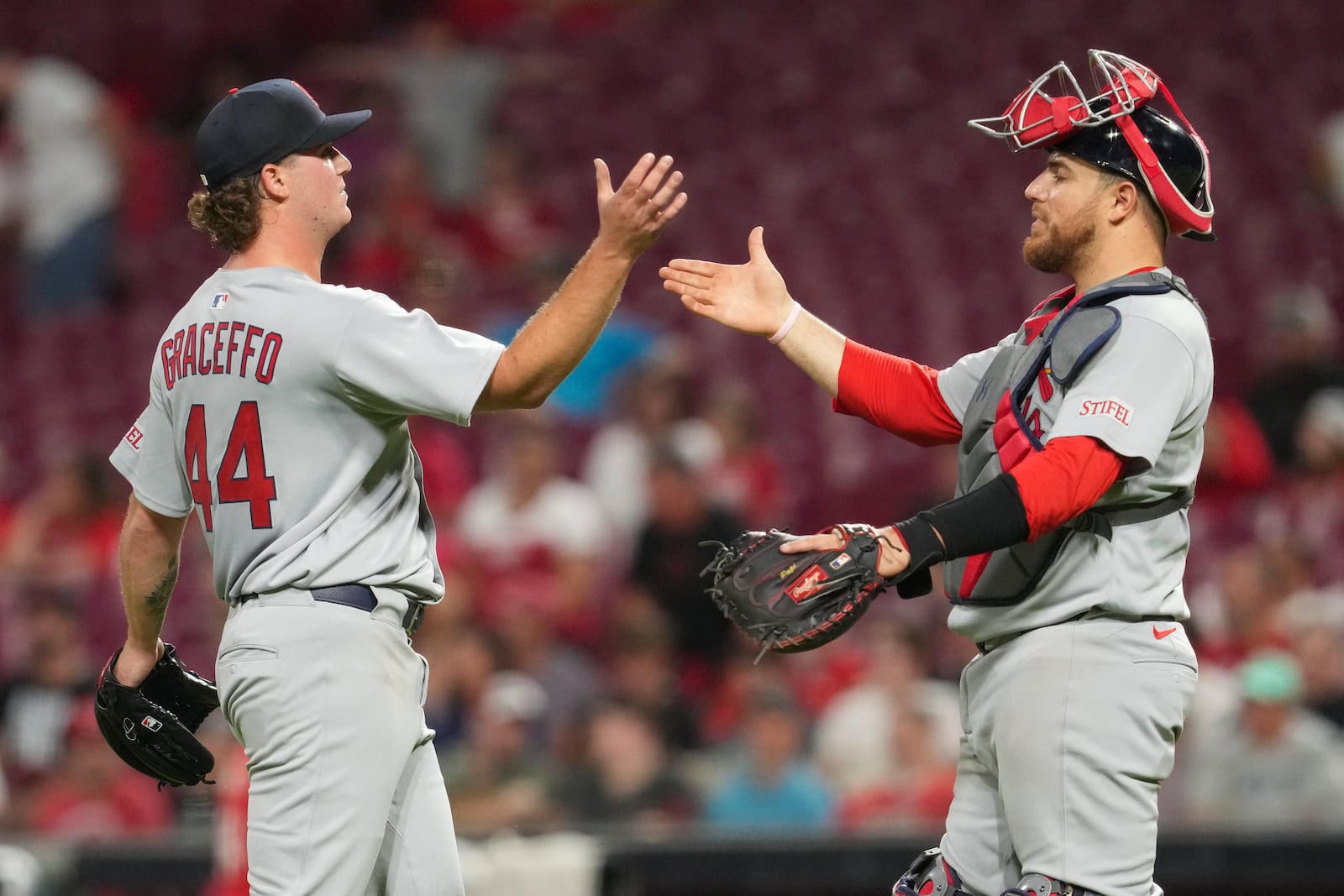St. Louis Cardinals' Gordon Graceffo (44) celebrates with teammate Pedro Pagés following the second baseball game of a doubleheader against the Cincinnati Reds, Wednesday, April 30, 2025, in Cincinnati. (AP Photo/Jeff Dean)