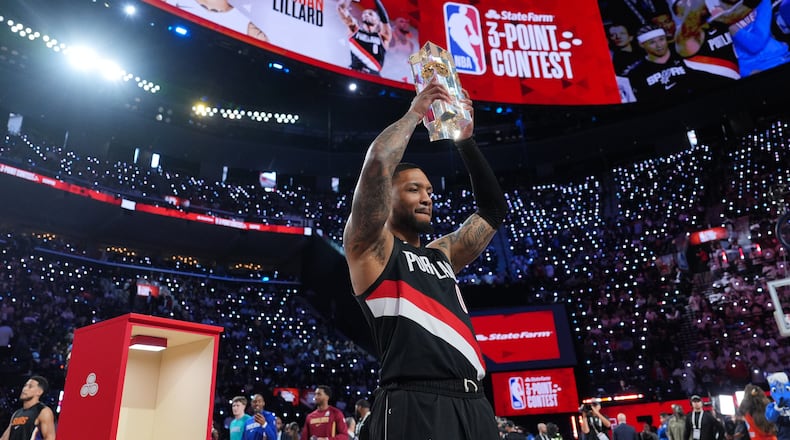 Portland Trailblazers guard Damian Lillard holds the winner's trophy after the 3-point contest at the NBA basketball All-Star weekend festivities Saturday, Feb. 14, 2026, in Inglewood, Calif. (AP Photo/Jae C. Hong)