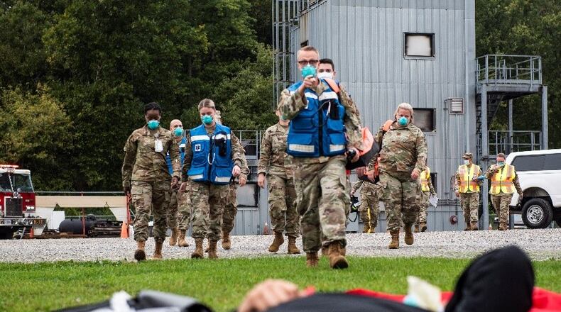 Additional medical support arrives on scene to help triage and care for “patients” during a simulated C-17 aircraft crash as part of an exercise Oct. 7 at Wright-Patterson Air Force Base. Readiness exercises are routinely held to streamline unit cohesion when responding to emergencies. (U.S. Air Force photo by Wesley Farnsworth)