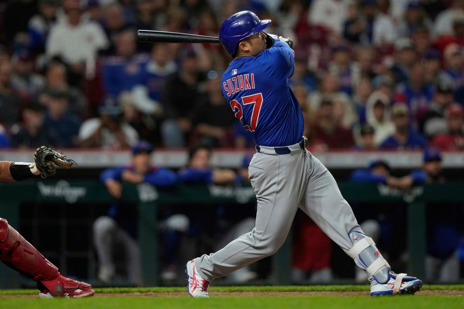 Chicago Cubs' Seiya Suzuki watches his three-run home run in the eighth inning of a baseball game against the Cincinnati Reds, Friday, May 23, 2025, in Cincinnati. (AP Photo/Carolyn Kaster)