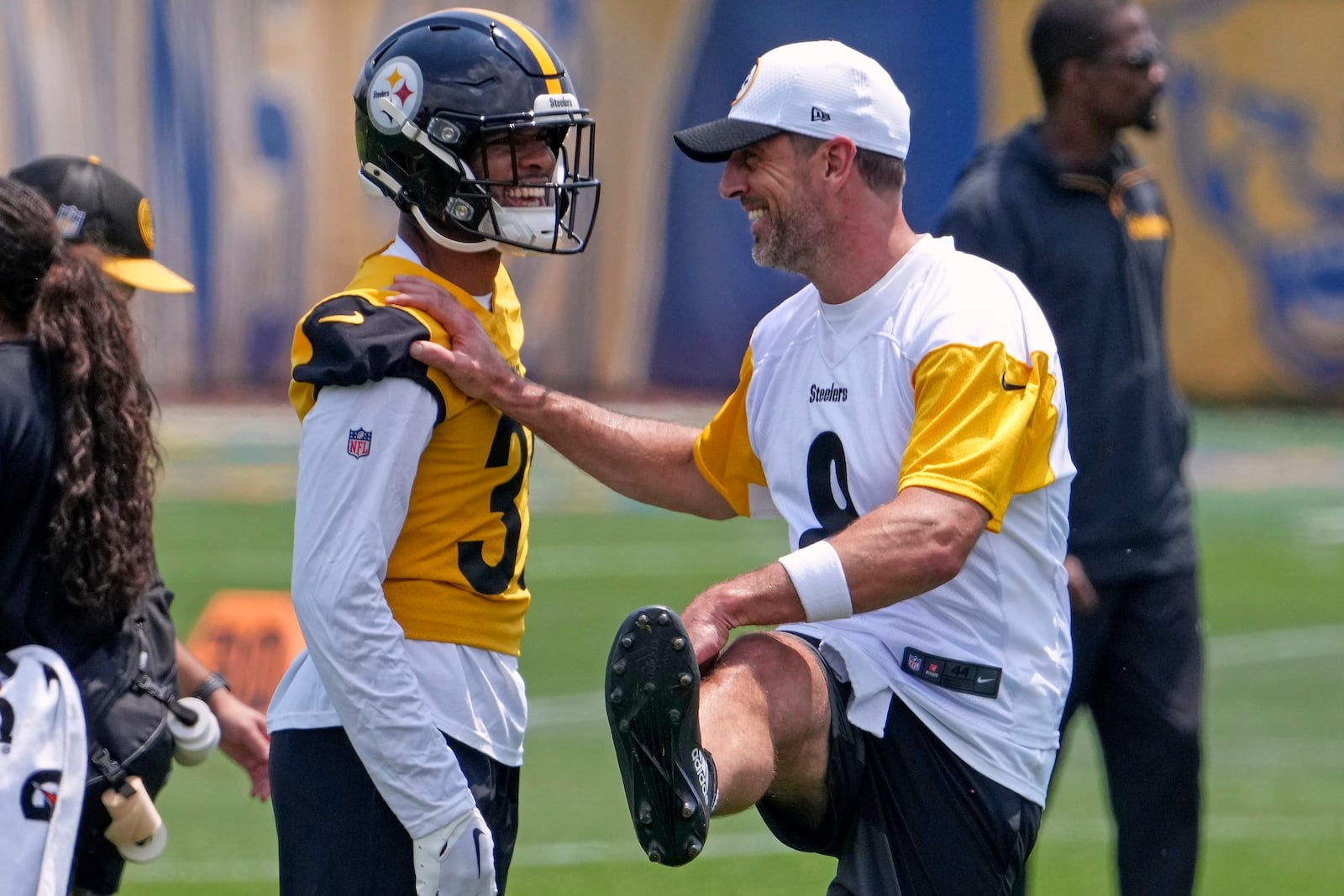 Pittsburgh Steelers quarterback Aaron Rodgers, right, and safety Quindell Johnson stretch during practice at NFL football minicamp, Tuesday, June 10, 2025, in Pittsburgh. (AP Photo/Gene J. Puskar)