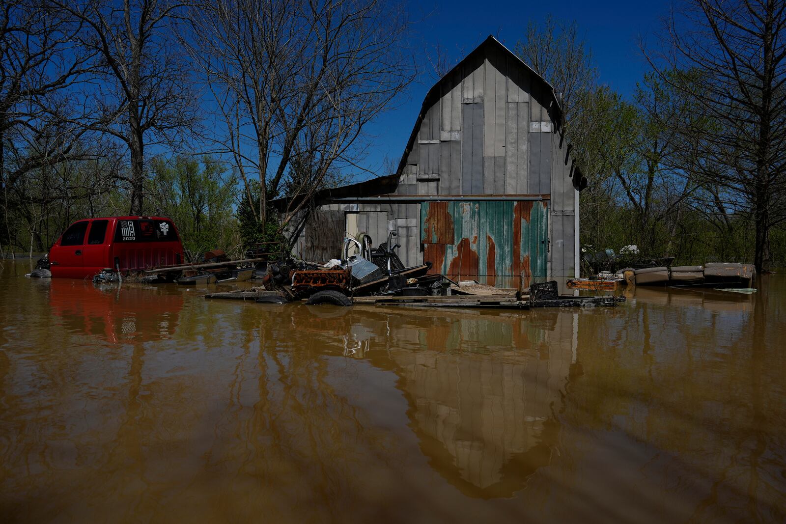 A barnyard is inundated by Kentucky River floodwaters in Lockport, Ky., Tuesday, April 8, 2025. (AP Photo/Carolyn Kaster)