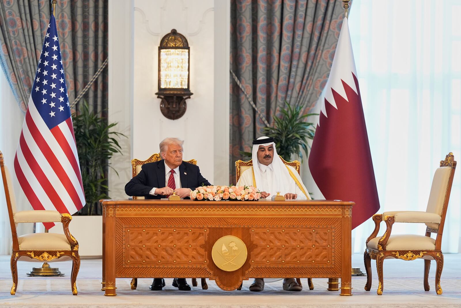 President Donald Trump and Qatar's Emir Sheikh Tamim bin Hamad Al Thani attend a signing ceremony at the Amiri Diwan in Doha, Qatar, Wednesday, May 14, 2025. (AP Photo/Alex Brandon)