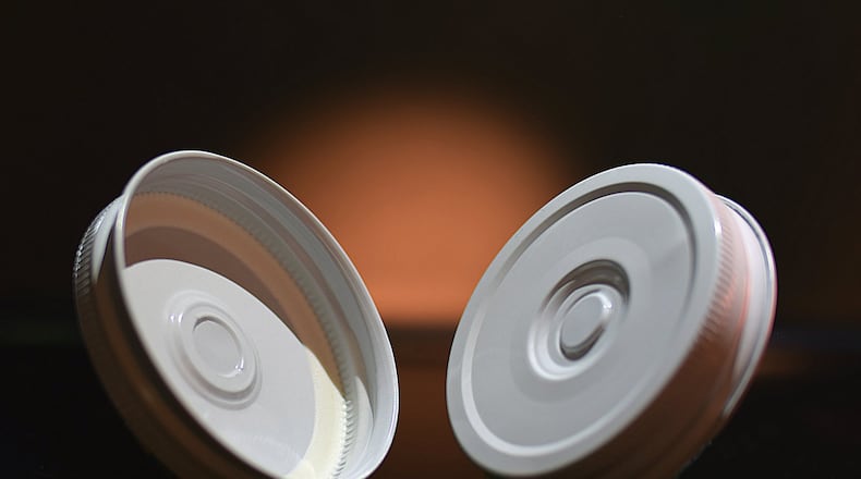 The Consumer Convenience Technologies new “EEASY Lid.” The lid unseals with far less torque force with the press of a button, its designers say. Production of the lids will begin soon in Dayton. CONTRIBUTED