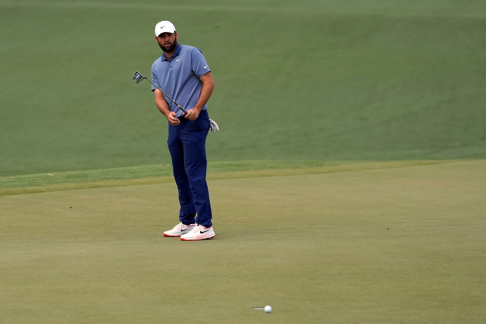 Scottie Scheffler reacts after missing a putt on the second hole during the second round at the Masters golf tournament, Friday, April 11, 2025, in Augusta, Ga. (AP Photo/Ashley Landis)