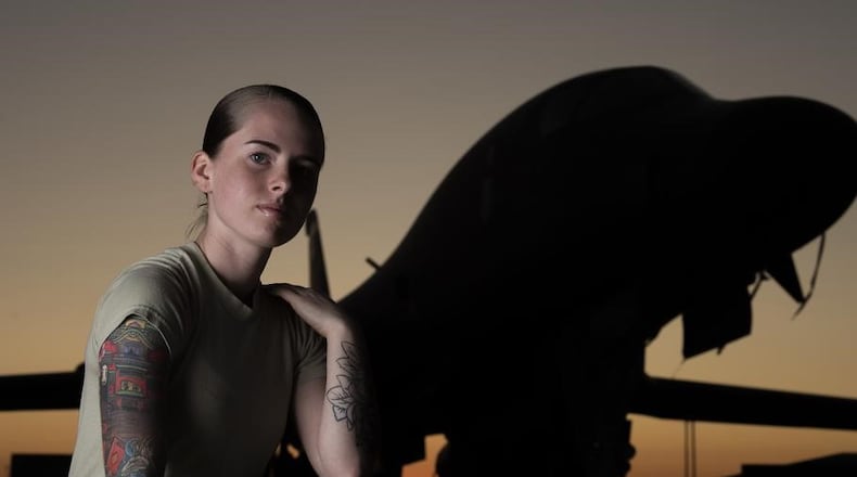 Senior Airman Autumn Rosado, 9th Aircraft Maintenance Unit avionics technician and a tattoo artist in her off-duty time, shows off her tattoos in front of a B-1B Lancer at Dyess Air Force Base, Texas, Sept. 18, 2019. A newly released Air Force regulation now allows airmen limited neck and hand tattoos. (River Bruce/U.S. Air Force)