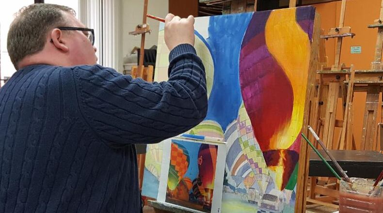 Duane Gordon, executive director of the Middletown Community Foundation, works on a collaborative painting that he and MAC painting instructor Karen Ng are contributing to the auction. CONTRIBUTED