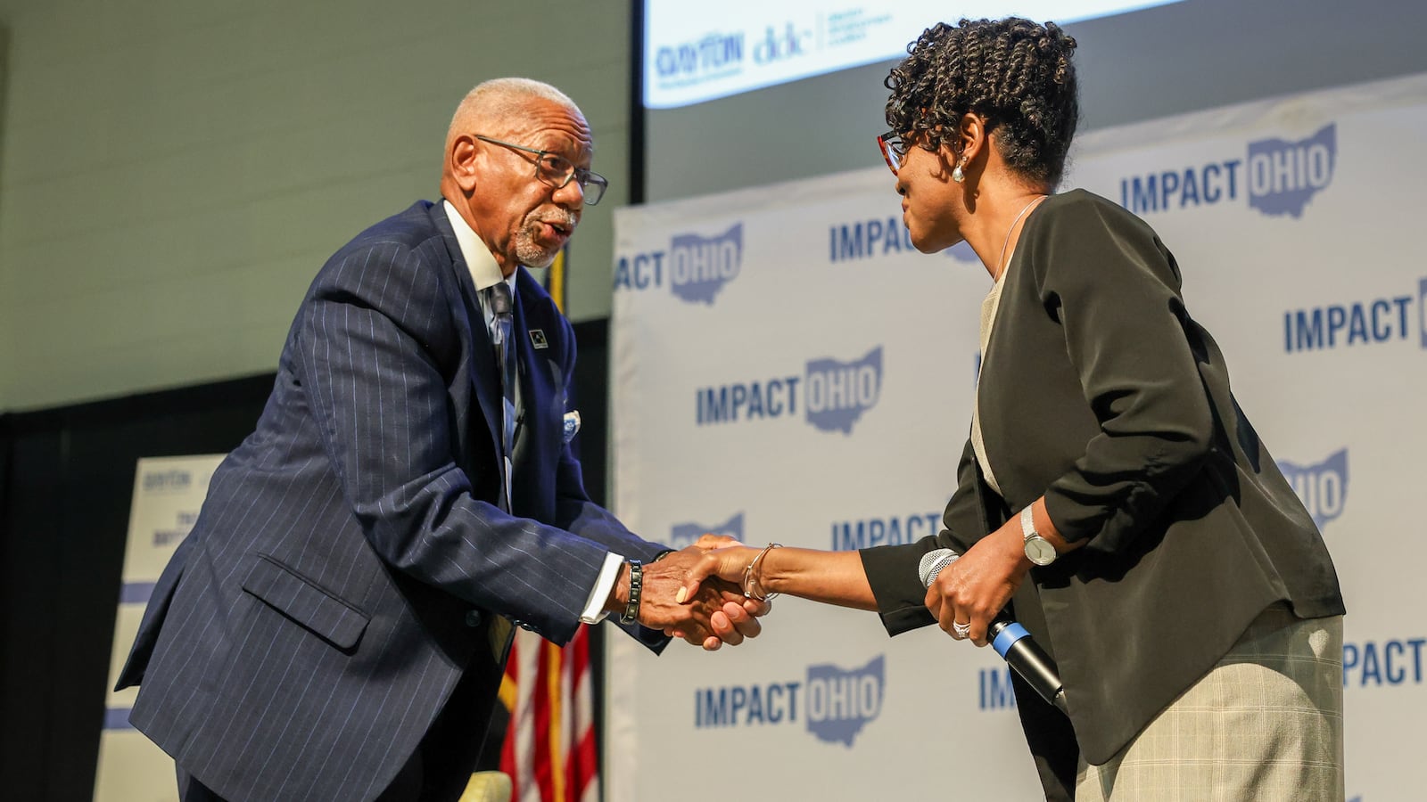 Dayton Mayor Jeffrey Mims Jr. shakes hands with city commissioner Shenise Turner-Sloss following a panel in the Ohio Chamber's 2025 Dayton Regional Impact Ohio Conference on Aug. 26 at Wright State University.  BRYANT BILLING / STAFF