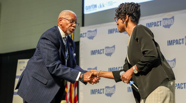 Dayton Mayor Jeffrey Mims Jr. shakes hands with city Commissioner Shenise Turner-Sloss following a panel in the Ohio Chamber's 2025 Dayton Regional Impact Ohio Conference on Tuesday, Aug. 26 at Wright State University. Turner-Sloss faces Mims in November's election. BRYANT BILLING / STAFF
