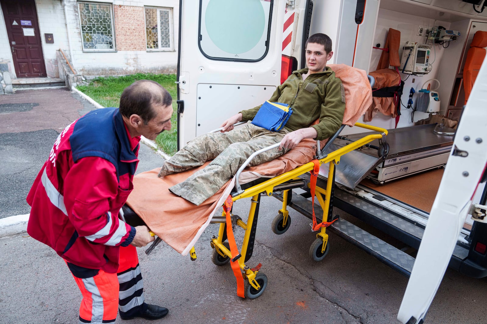 A medical worker moves an injured Ukrainian soldier from an ambulance after returning from captivity in a POW exchange in Ukraine, on Saturday, April. 19, 2025. (AP Photo/Evgeniy Maloletka)