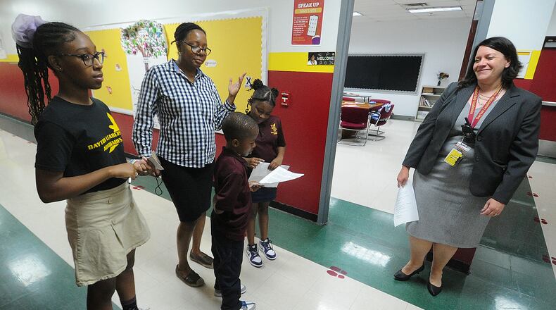 The Dayton Leadership Academy's tour team, from left, Amyah Owens, teacher Nicole Mitchell, Ayden Jamison, Ariah Jamison and the school's executive director, Tess Mitchner Asinjo, in a fall 2023 photo. MARSHALL GORBY\STAFF