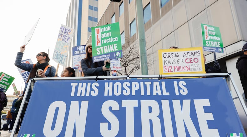 Members of the United Nurses Associations of California and Union of Healthcare Professionals strike outside of Kaiser Permanente on Broadway in Oakland, Calif., on Wednesday, Jan. 28, 2026. (Jessica Christian/San Francisco Chronicle via AP)