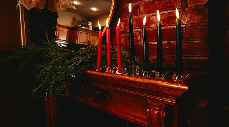 The kinara, or candleholder, on the mantle of Krystal Stark and Kerry Coddett, in New York, Dec. 11, 20020. The seven candles (red, black and green) represent the seven Kwanzaa values. (Timothy Smith/The New York Times)