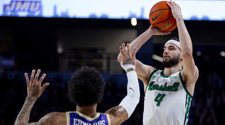 Marshall guard Jacob Conner (4) shoots against James Madison guard Terrence Edwards Jr. (5) during the first half of an NCAA college basketball game in Harrisonburg, Va., Saturday, Jan. 20, 2024. (Daniel Lin/Daily News-Record via AP)