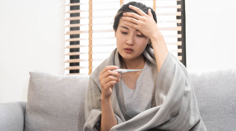Seasonal influenza, like COVID-19, is a contagious respiratory illness that disproportionately affects adults ages 65 and older. KMPZZZ/SHUTTERSTOCK