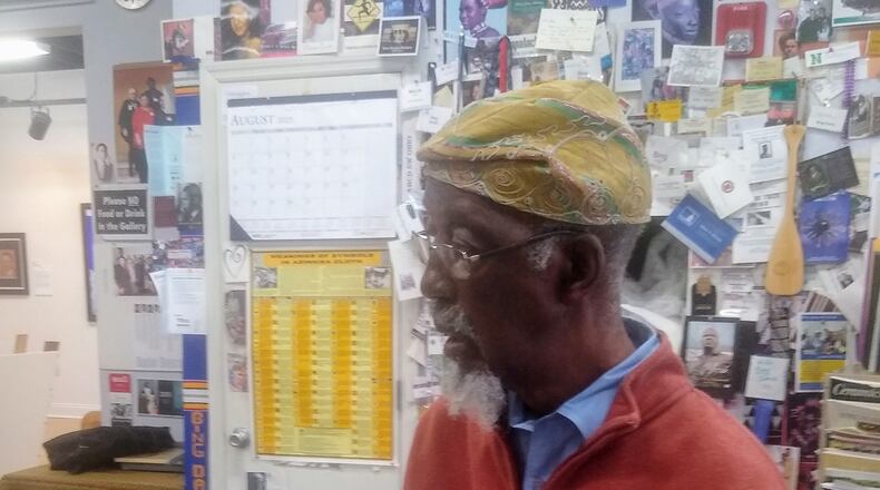 Artist Bing Davis listens intently as former students share memories. Contributed