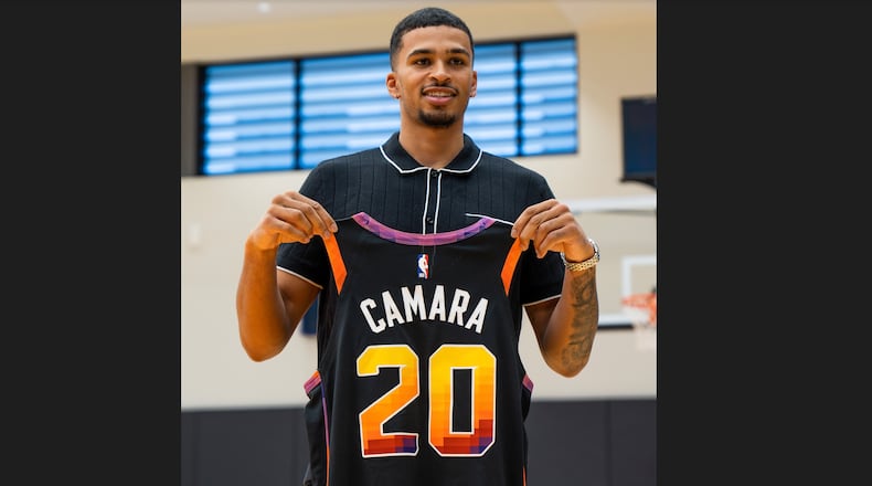 Toumani Camara poses for a photo with a Suns jersey in Phoenix, Ariz., on Tuesday, June 27, 2023. Photo courtesy of the Phoenix Suns.