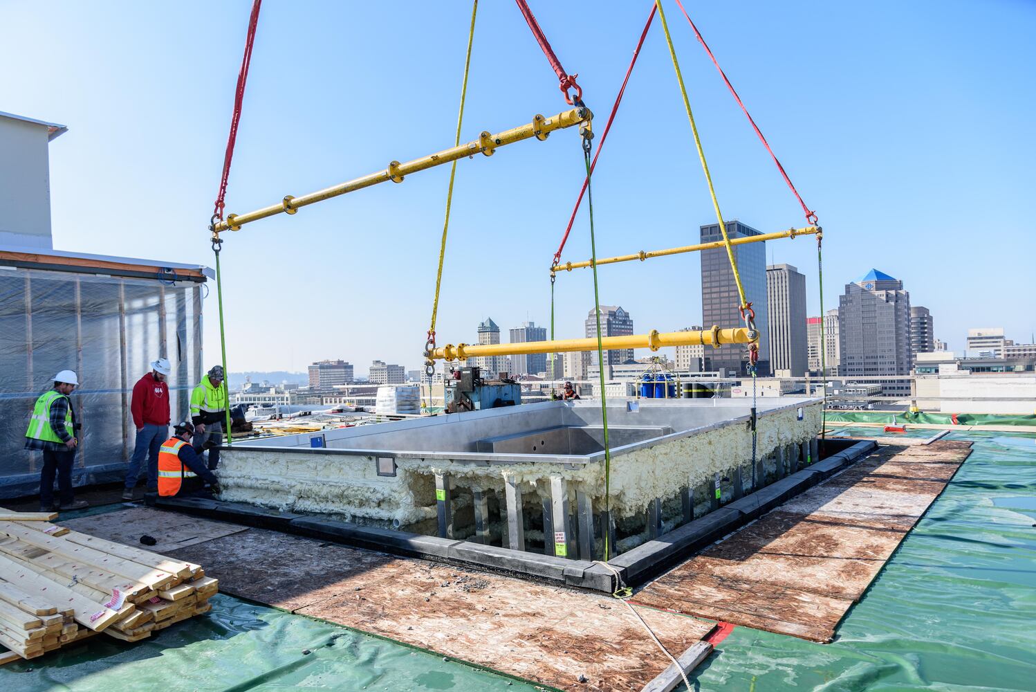 PHOTOS: Crane lifts swimming pool to The Delco's rooftop in downtown Dayton