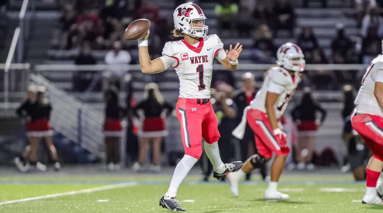 Wayne High School senior quarterback Tyrell Lewis prepares to throw a pass during their game against Springfield on Friday night in Springfield. The Warriors won 36-6. CONTRIBUTED PHOTO BY MICHAEL COOPER