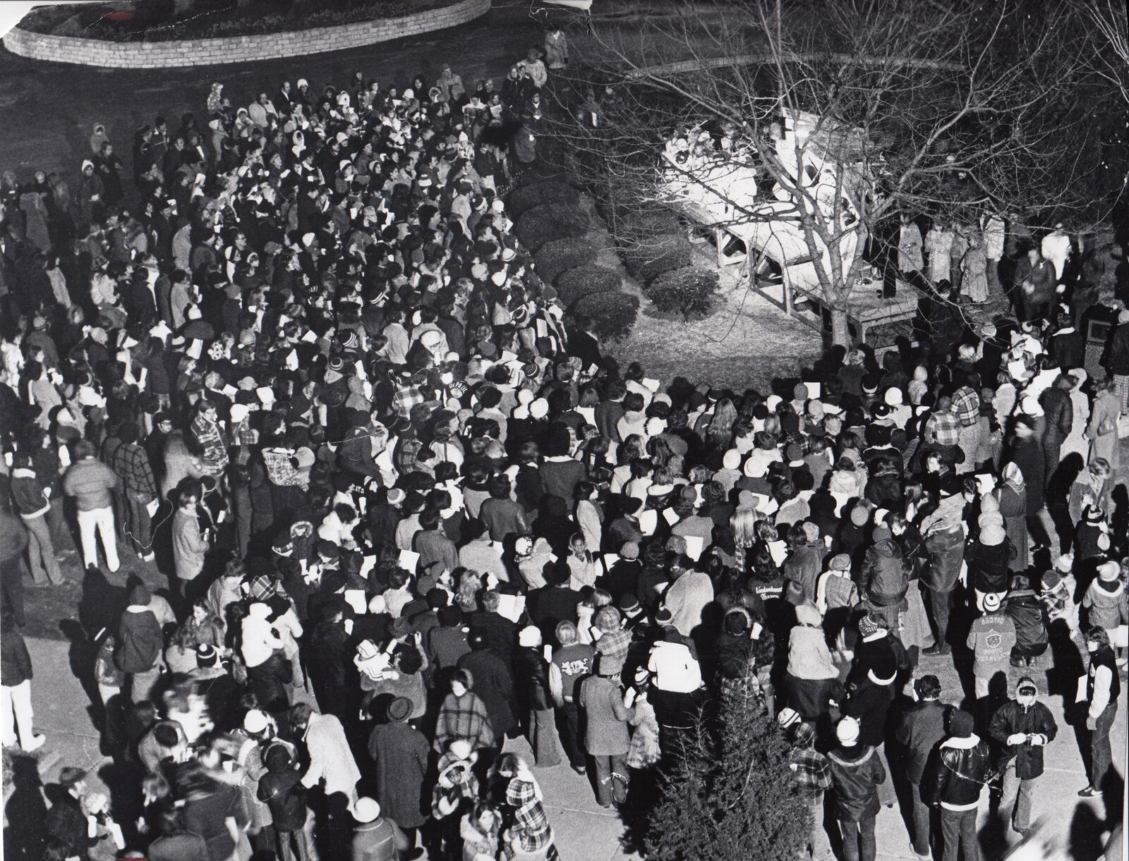 In 1976 hundreds of University of Dayton students, faculty and guests gather on Kennedy Union Plaza for carols by candle light duiring the Christmas on Campus celebration. DAYTON DAILY NEWS ARCHIVE