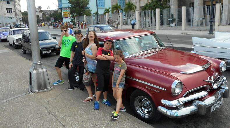 Kids from Adonia mugging for camera in front of vintage ’50s-era American car in Old Havana. (Andy Yemma)
