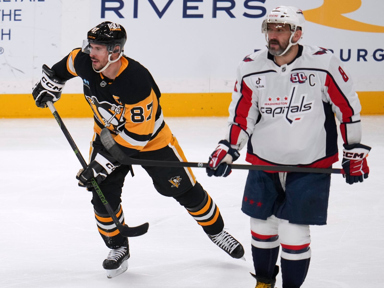 Pittsburgh Penguins' Sidney Crosby (87) and Washington Capitals' Alex Ovechkin (8) skate during the first period of an NHL hockey game in Pittsburgh, Thursday, April 17, 2025. (AP Photo/Gene J. Puskar)