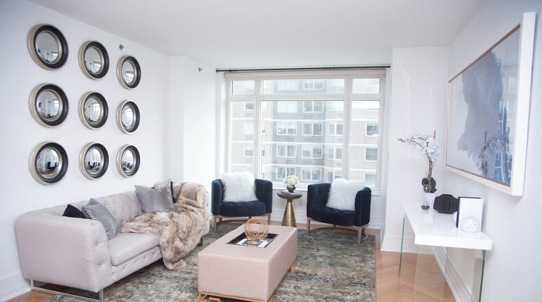 The odd number grouping of nine identical mirrors makes a powerful design statement in this living room. (Hannah Rokes/TNS)