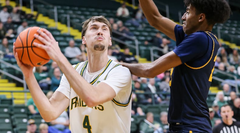 Wright State freshman forward Kellen Pickett shoots with pressure from Franklin College's Dylan Beverly during a nonconference game on Monday, Nov. 3 at Ervin J. Nutter Center in Fairborn. Pickett scored seven points and had five rebounds and three assists. BRYANT BILLING/STAFF