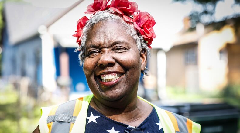 Retired Dayton resident Vendola Lawrence walks around her neighborhood on the city's west side cleaning trash from the streets, alleys and vacant lots. JIM NOELKER/STAFF
