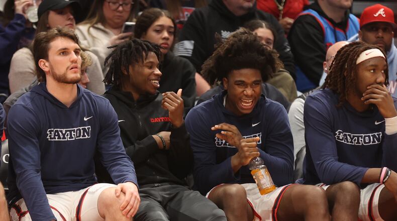Dayton's Malachi Smith and Marvel Allen laugh on the bench during a game against Fordham on Saturday, Feb. 17, 2024, at UD Arena. David Jablonski/Staff