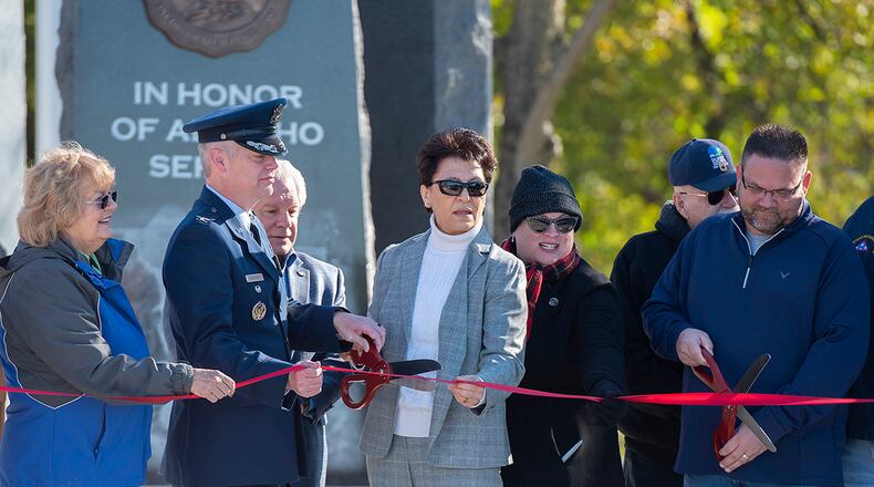 Col. Charles Barkhurst, 88th Air Base Wing vice commander, and retired Air Force Col. Cassie Barlow (center), former 88 ABW commander, cut the ribbon on the new Veterans Memorial Park during a dedication ceremony Nov. 6 at Thomas A. Cloud Park in Huber Heights. Members of the Huber Heights City Council and Military and Veterans Commission also took part. U.S. AIR FORCE PHOTO/R.J. ORIEZ