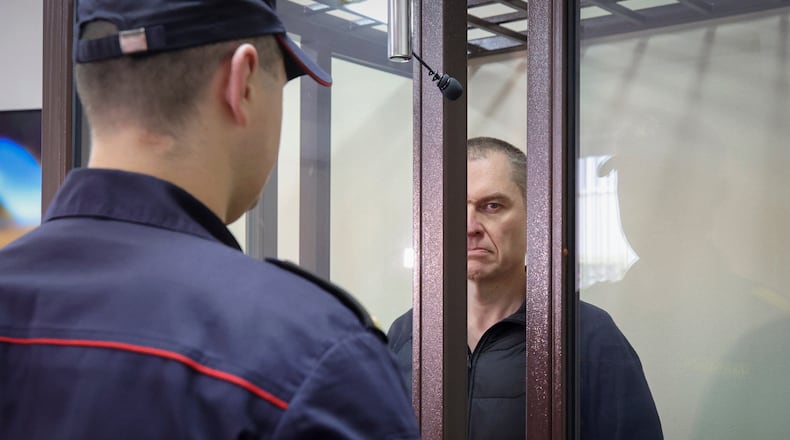 FILE -Journalist Andrzej Poczobut stands in a defendants' cage during a court session in Grodno, Belarus, Jan. 16, 2023. (Leonid Shcheglov/Pool via AP, File)