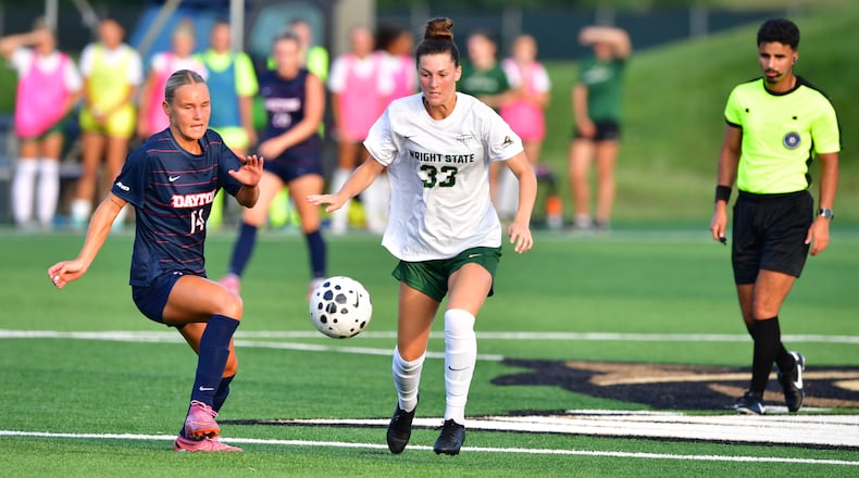 Wright State University junior Caitlin Burger dribbles past Dayton senior Riley Kerber during their match earlier this season in Fairborn. JOSEPH R. CRAVEN / WRIGHT STATE ATHLETICS