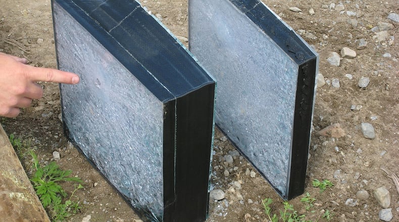 A projectile exit point is shown in the ballistic glass (left). The aluminum oxynitride transparent ceramic armor is shown (right) with a bulge and no exit from the projectile. (Courtesy photo)