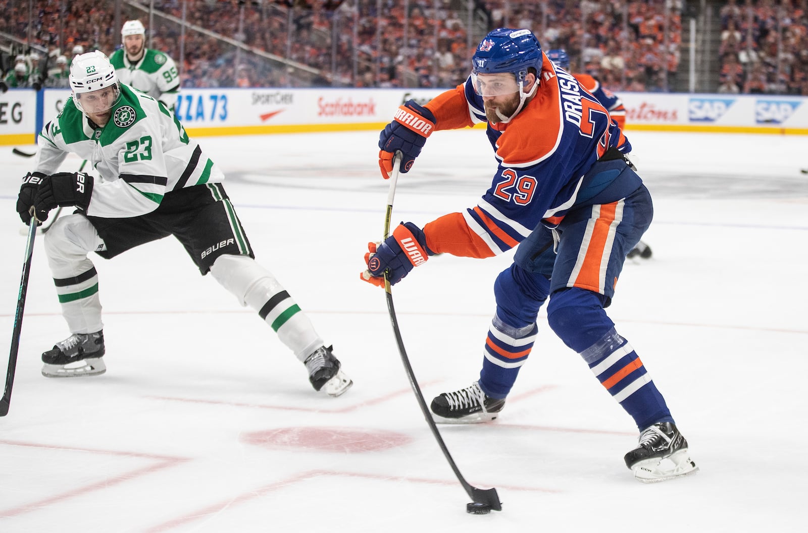 Dallas Stars' Esa Lindell (23) chases down Edmonton Oilers' Leon Draisaitl (29) as he gets a shot away during second period NHL Western Conference final playoff action, in Edmonton on Tuesday, May 27, 2025. (Jason Franson/The Canadian Press via AP)