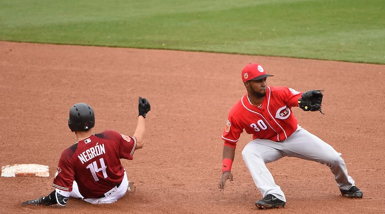 SCOTTSDALE, AZ - FEBRUARY 27: Kris Negron #14 of the Arizona Diamondbacks slides safely into second base during the fifth inning as Alcantara Arismendy #30 of the Cincinnati Reds makes a play on a throw in the dirt from right field at Salt River Fields at Talking Stick on February 27, 2017 in Scottsdale, Arizona. (Photo by Norm Hall/Getty Images)