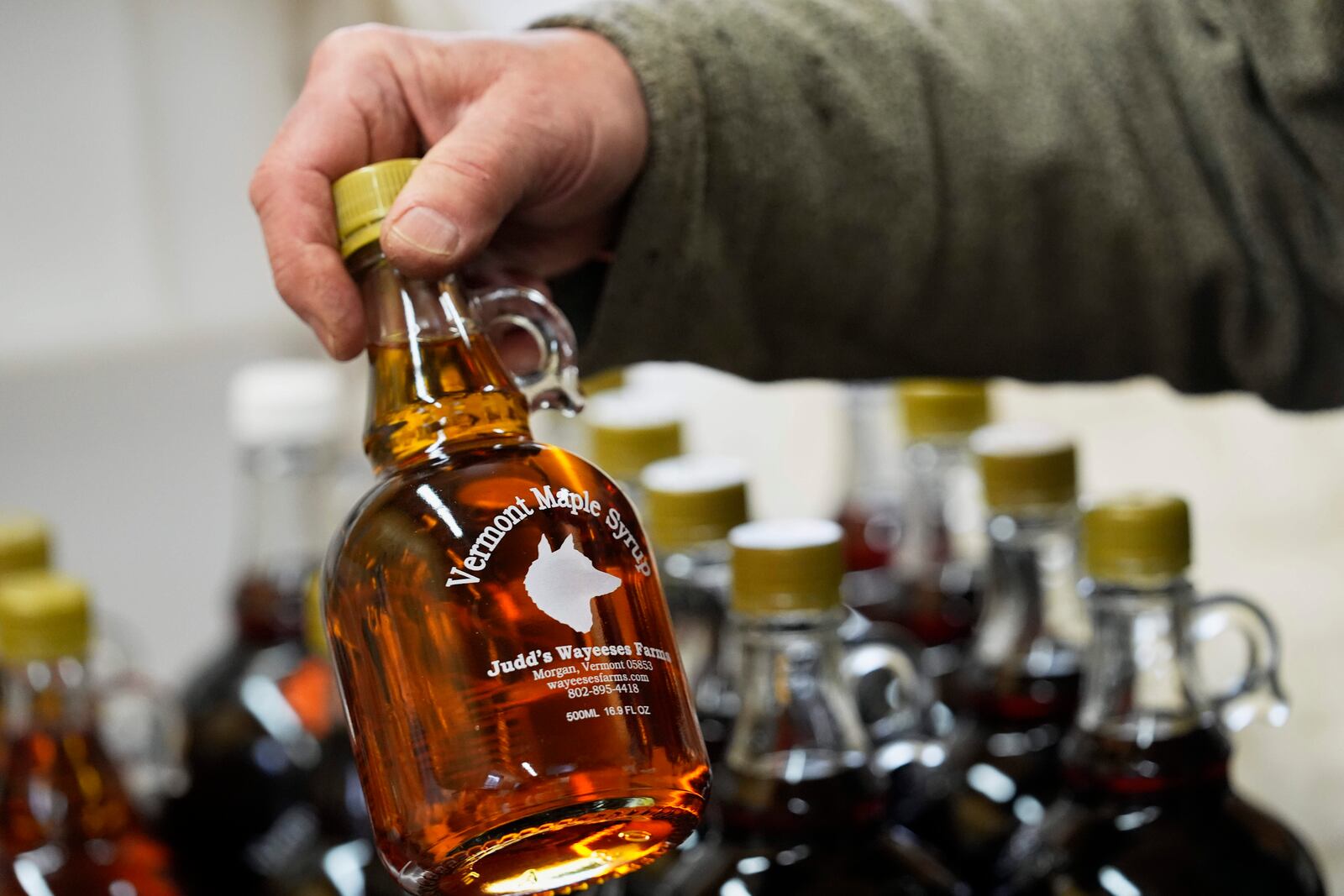 A bottle of maple syrup is placed on a shelf at Judd's Wayeeses Farms in Morgan, Vt., on Friday, April 11, 2025. (AP Photo/Robert F. Bukaty)