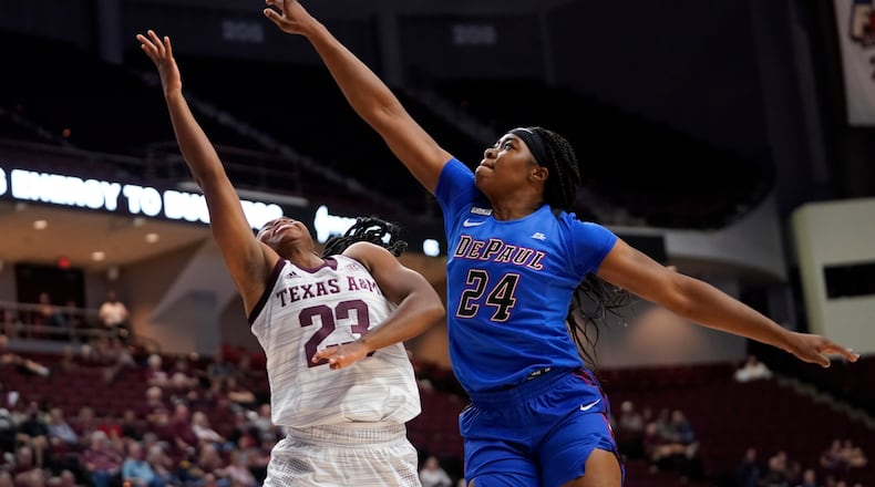 DePaul forward Aneesah Morrow (24) blocks a shot by Texas A&M guard McKinzie Green (23) during the first half of an NCAA college basketball game Monday, Nov. 15, 2021, in College Station, Texas. (AP Photo/Sam Craft)