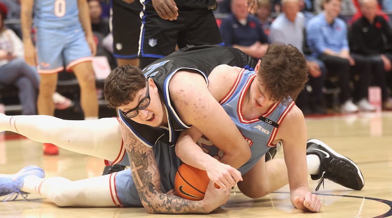 Dayton's Amaël L'Etang, right, and Robbie Avila, of Saint Louis, compete for a loose ball on Tuesday, March 4, 2025, at UD Arena. David Jablonski/Staff