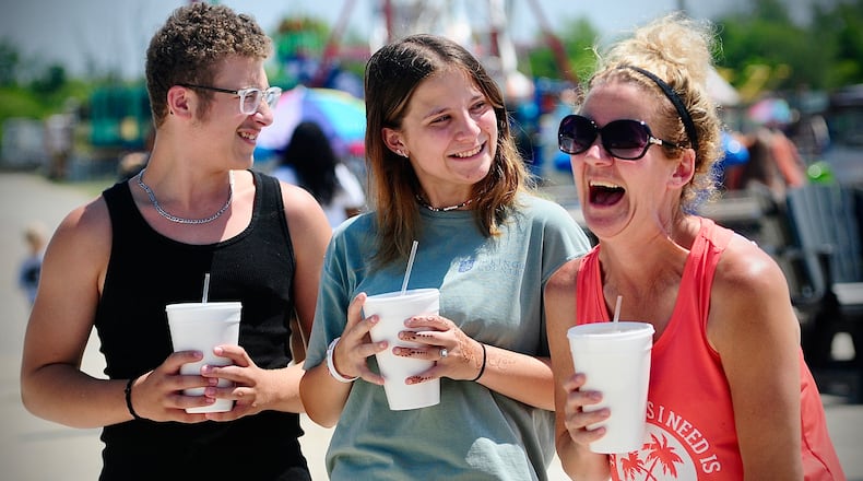 Montgomery County Fair goers, from left, Myles Calondis, Emma and Kimberly Holtzman all agreed Thursday, July 11, 2024 that lemonade was their favorite fair drink. MARSHALL GORBY\STAFF
