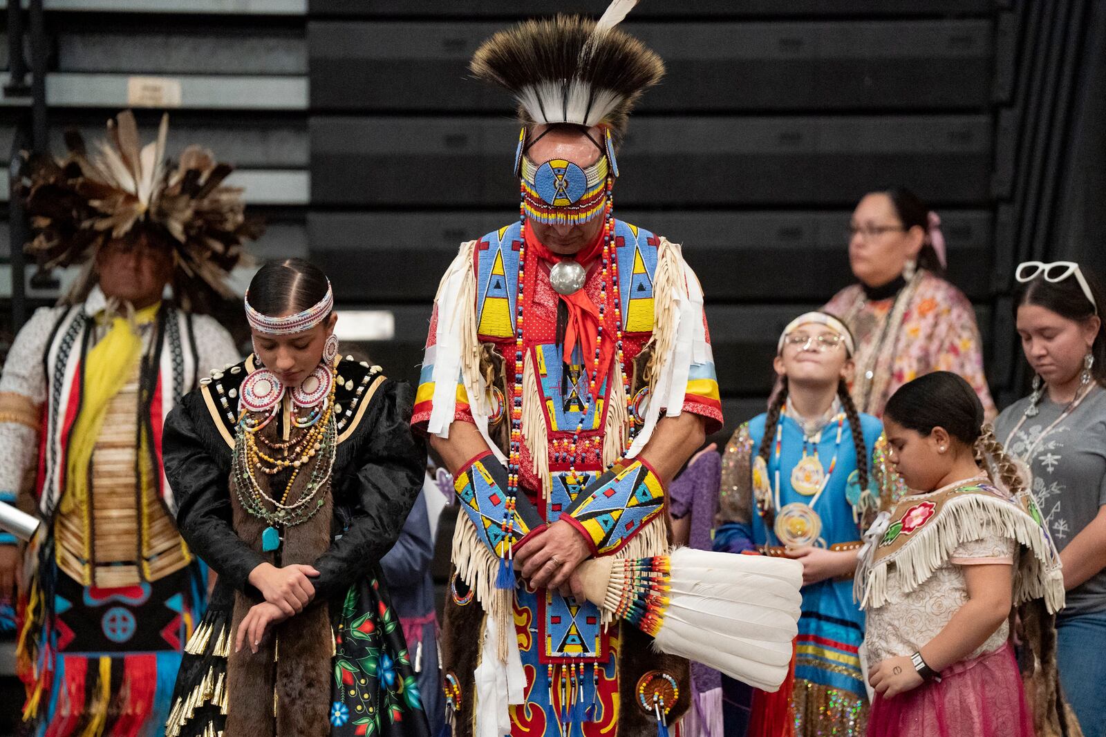 People bow their heads in prayer during the BraveNation Powwow and Gather at UNC Pembroke, Saturday, March 22, 2025, in Pembroke, N.C. (AP Photo/Allison Joyce)