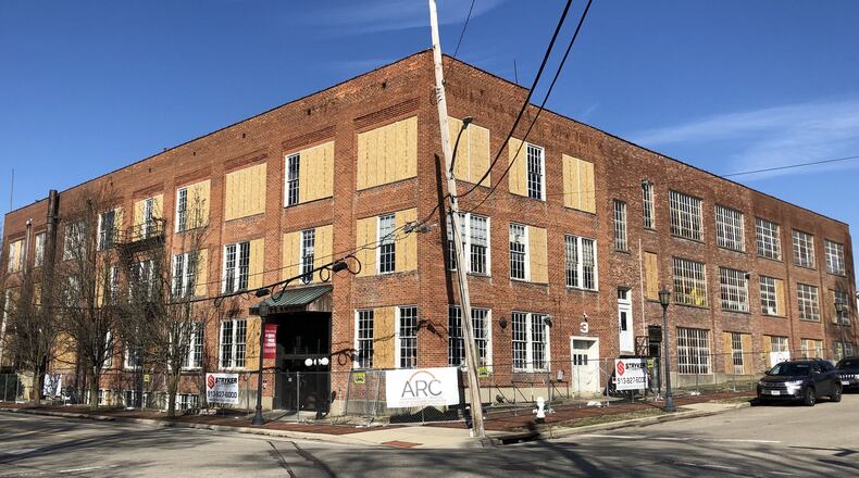 The broken windows in the former shoe factory in Lebanon have been boarded up, prompting the city to dismiss a lawsuit filed against the building’s owners.STAFF/LAWRENCE BUDD