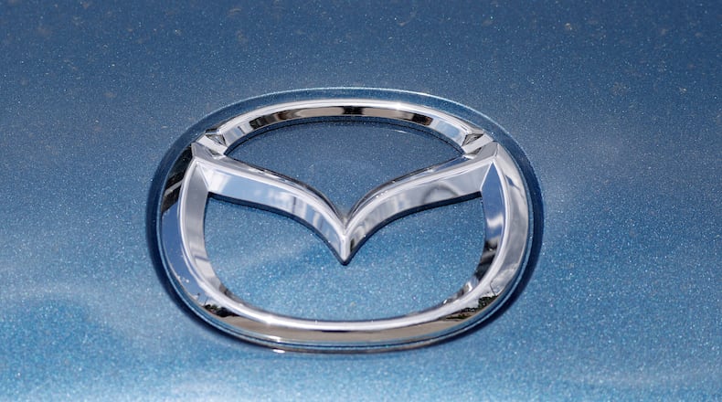 In this June 14, 2020, photograph, a Mazda company logo shines on the front of an unsold 2020 Miata at a Mazda dealership in Littleton, Colo. On Thursday, Nov. 19, Mazda beat traditional winners Lexus and Toyota to win top honors as the most dependable auto brand in Consumer Reports’ annual reliability survey.   Reports surveyed organization members who own more than 300,000 vehicles from model years 2000 to 2020.  (AP Photo/David Zalubowski)