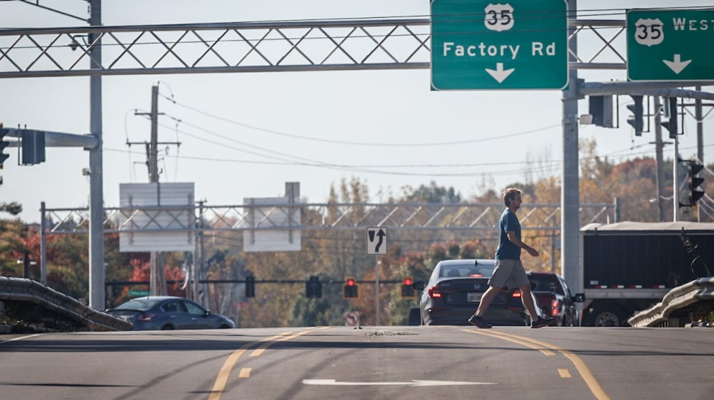 A pedestrian walks across the Factory Road bridge in Beavercreek. The city council recently purchased land near Factory Road, including where RaceTrac had proposed an unpopular truck stop last year, to prevent "incompatible" development and secure the land for a potential future overpass. FILE