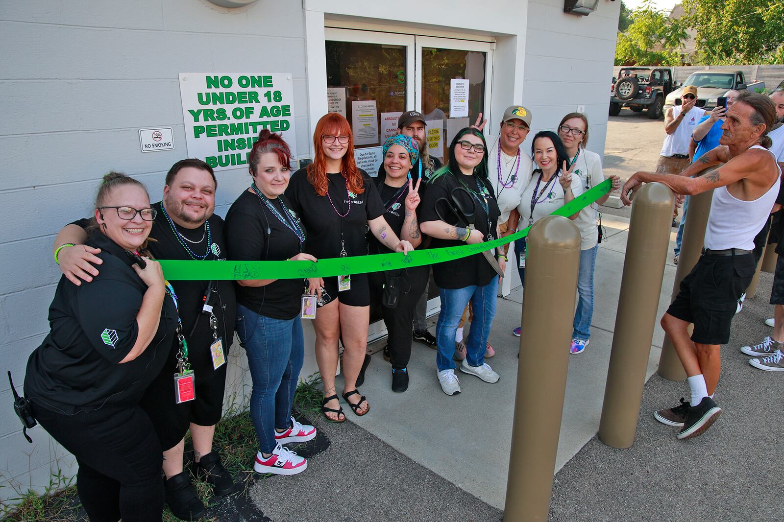The staff of Springfield marijuana business The Forest held a ribbon-cutting Tuesday, August 6, 2024 before the beginning of legal recreational marijuana sales. BILL LACKEY/STAFF