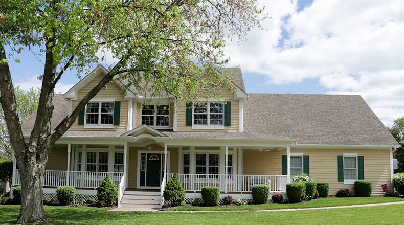 Two covered porches allow for outdoor entertainment off this 2-story home, which has about 5,200 sq. ft. of living space. A finished walk-out lower level offers a family room, recreation room, full bathroom and two bonus rooms. There is a first-floor main bedroom and possible 4 upstairs bedrooms. CONTRIBUTED PHOTO BY KATHY TYLER