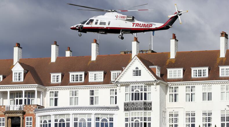 FILE - In this July 29, 2015 file photo, a helicopter owned by Donald Trump departs from the Turnberry golf course in Turnberry, Scotland. Feelings toward Trump run from anger to praise in Scotland where the troubles for the presidentâs two golf clubs have only mounted recently. A financial report filed with the British government shows Trump is losing millions for a third year in a row. (AP Photo/Scott Heppell, File)