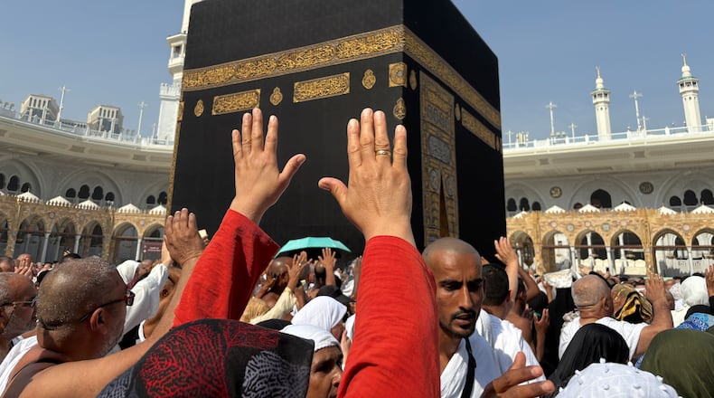 FILE - Muslim pilgrims pray as they circumambulate the Kaaba, the cubic building at the Grand Mosque, during the minor pilgrimage, known as Umrah, in the Muslim holy city of Mecca, Saudi Arabia, Sunday, Dec. 7, 2025. (AP Photo/Amr Nabil, File)